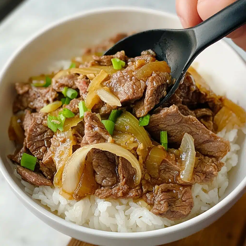 Gyudon Japanese Beef Rice Bowl, Japanese beef donburi, quick Japanese beef bowl, easy Gyudon recipe, homemade Japanese beef bowl A white bowl filled with a layer of white rice at the bottom, topped with a mix of thin slices of cooked brown beef and translucent cooked onion pieces, with some light green scallion pieces scattered on top. A black spoon is scooping some of the beef and onion mixture, and a woman's hand is holding the bowl from the side. The background shows a white marbled surface.