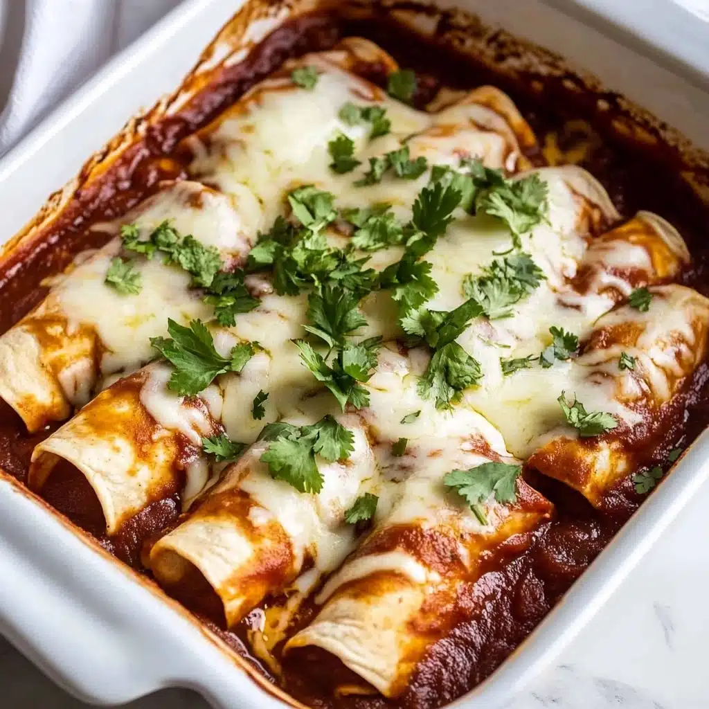 Beef Enchiladas, Beef Enchiladas without recipe, Easy Beef Enchiladas, Homemade Beef Enchiladas, Spicy Beef Enchiladas The image shows a white baking dish filled with five rolled tortillas covered in a dark red sauce. The tortillas are tightly packed in the dish, their edges slightly browned. On top, there is a layer of melted white cheese that looks soft and stringy, spreading unevenly over the sauce and tortillas. Fresh green chopped cilantro is sprinkled over the cheese, adding a bright contrast. The dish is placed on a white marbled surface, with a white cloth visible to the side.