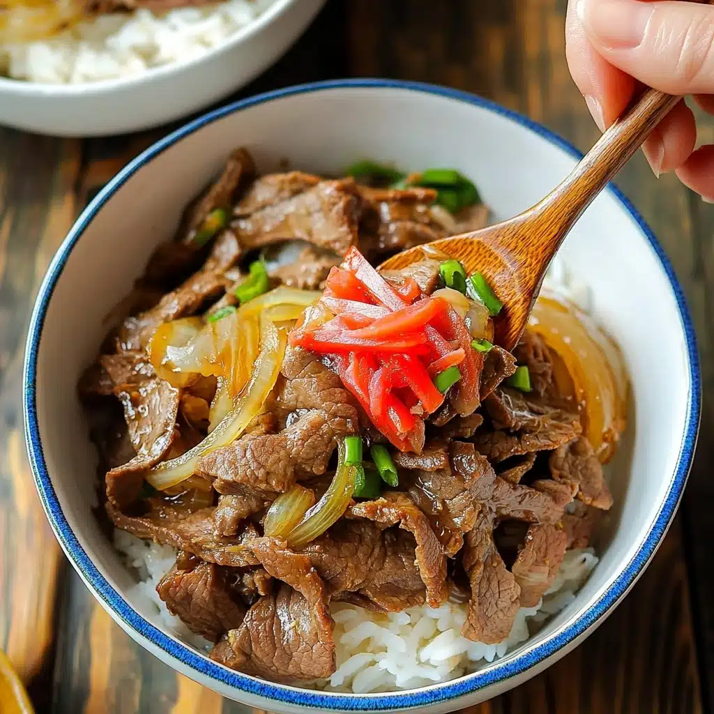 Gyudon Japanese Beef Rice Bowl, Japanese beef donburi, quick Japanese beef bowl, easy Gyudon recipe, homemade Japanese beef bowl A white bowl holds a layered dish starting with a base of steamed rice, topped by thin slices of cooked brown beef mixed with light yellow translucent cooked onions, green onion pieces, and a garnish of bright red pickled ginger strips in the center. A woman's hand holds a wooden spoon lifting a portion of the beef, onions, and rice from the bowl, which has a blue rim. The bowl is placed on a wooden table, and another white bowl with a blue rim and lid appears partly in view.