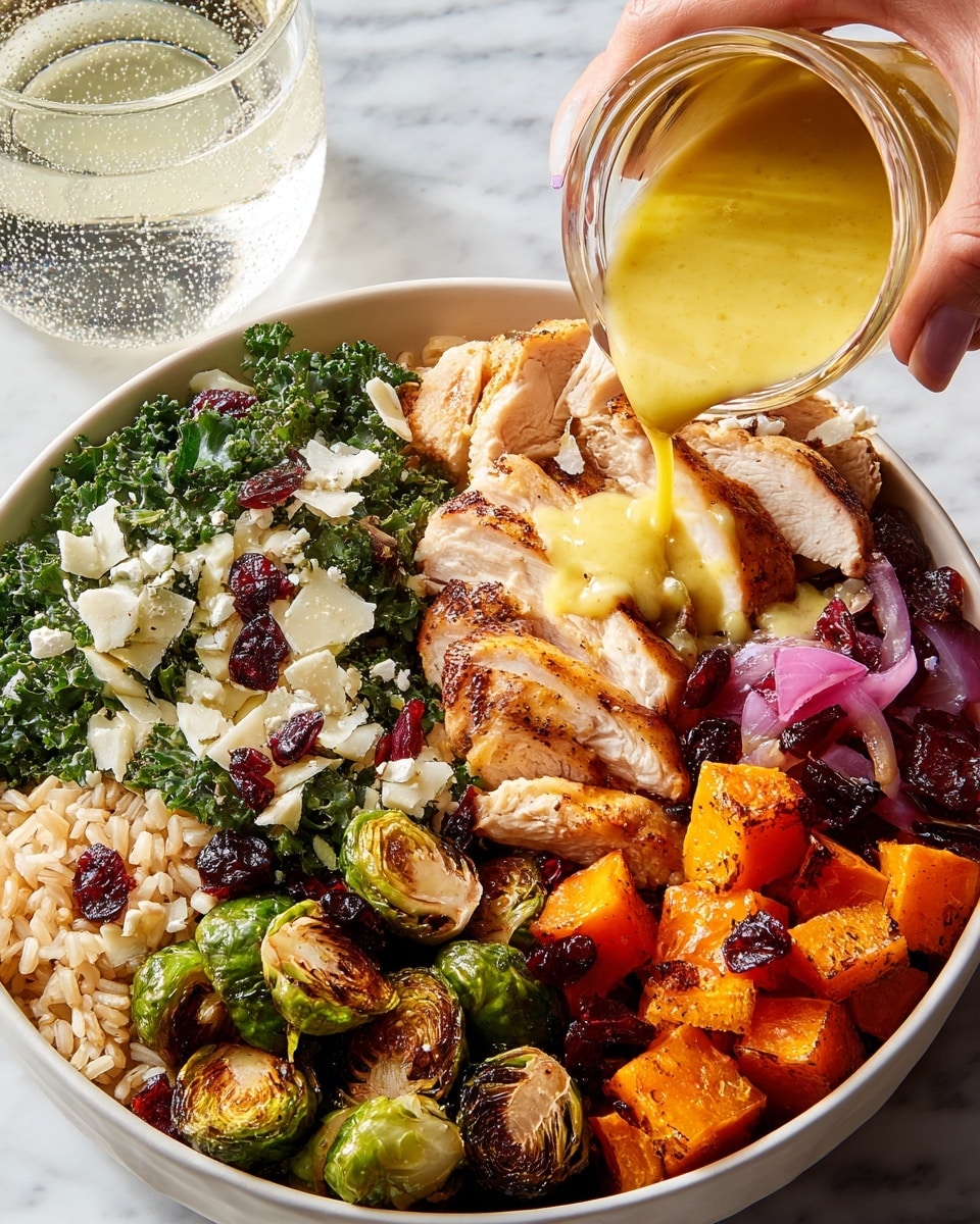 A white bowl sits on a white marbled surface, filled with five distinct layers: at the bottom left, light brown rice grains; next to it, curly green kale leaves mixed with small white cheese chunks and dark red dried cranberries; beside the kale, golden brown sliced grilled chicken with light sear marks, being drizzled with a thick yellow sauce from a clear glass cup held by a woman's hand; next to the chicken, roasted orange sweet potato cubes; and in front of the sweet potatoes, roasted green Brussels sprouts with a slight char, mixed with some diced purple onions. In the background, a clear glass of water with bubbles adds to the fresh look. photo taken with an iphone --ar 4:5 --v 7