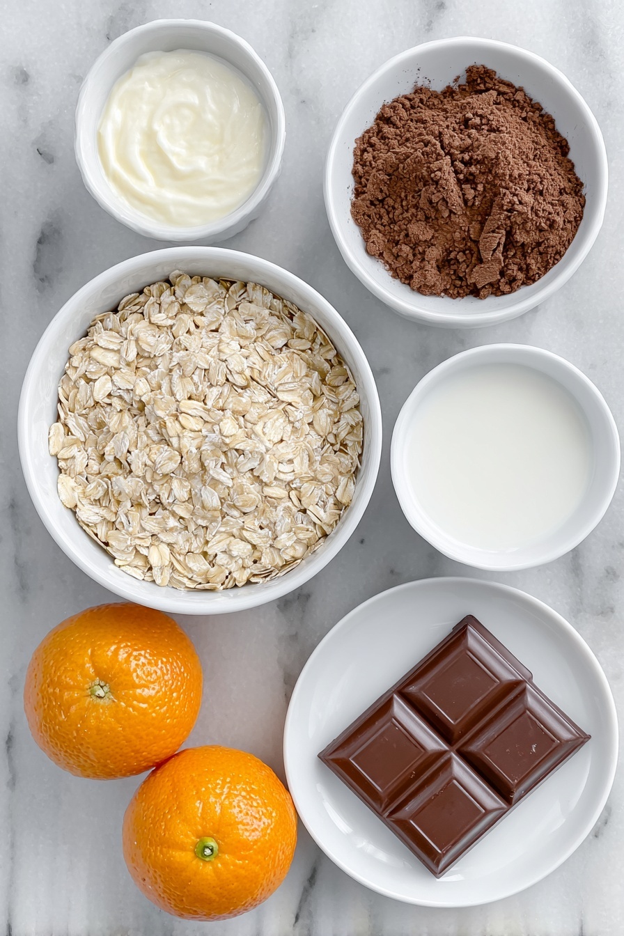 Flat lay of a small white ceramic bowl filled with pale beige porridge oats, a small white bowl of creamy semi-skimmed milk, a small white bowl of clear water, a small white bowl of rich dark brown cocoa powder, two bright orange satsumas—one whole and one cut in half showing juicy segments, and a single square of glossy dark chocolate placed on a white ceramic plate, all arranged in perfect symmetry, placed on a clean white marble surface, soft natural light, photo taken with an iPhone, professional food photography style, fresh ingredients, white ceramic bowls, no bottles, no duplicates, no utensils, no packaging --ar 2:3 --v 7 --p m7354615311229779997 - Chocolate Orange Porridge, easy breakfast ideas, healthy citrus breakfast, quick morning recipes, comforting porridge with chocolate