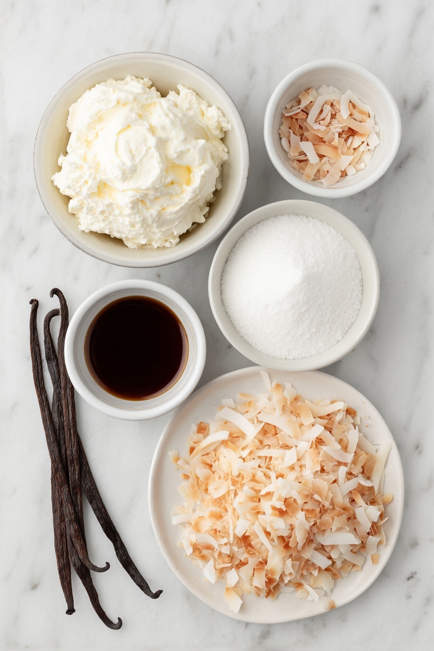 Flat lay of a small mound of cold heavy cream in a simple white ceramic bowl, a small white bowl filled with fine powdered sugar, a few whole brown vanilla beans beside a tiny white bowl holding vanilla extract, a larger white bowl containing cold full-fat coconut milk, a small white bowl with cold sweetened condensed milk, a tiny white bowl with coconut extract, and a neat pile of toasted unsweetened shredded coconut flakes on a white ceramic plate, all arranged symmetrically and naturally with fresh, unprocessed appearance placed on a clean white marble surface, soft natural light, photo taken with an iPhone, professional food photography style, fresh ingredients, white ceramic bowls, no bottles, no duplicates, no utensils, no packaging --ar 2:3 --v 7 --p m7354615311229779997 - Homemade Coconut Ice Cream, coconut ice cream recipe, tropical frozen dessert, easy coconut ice cream, no-churn coconut ice cream