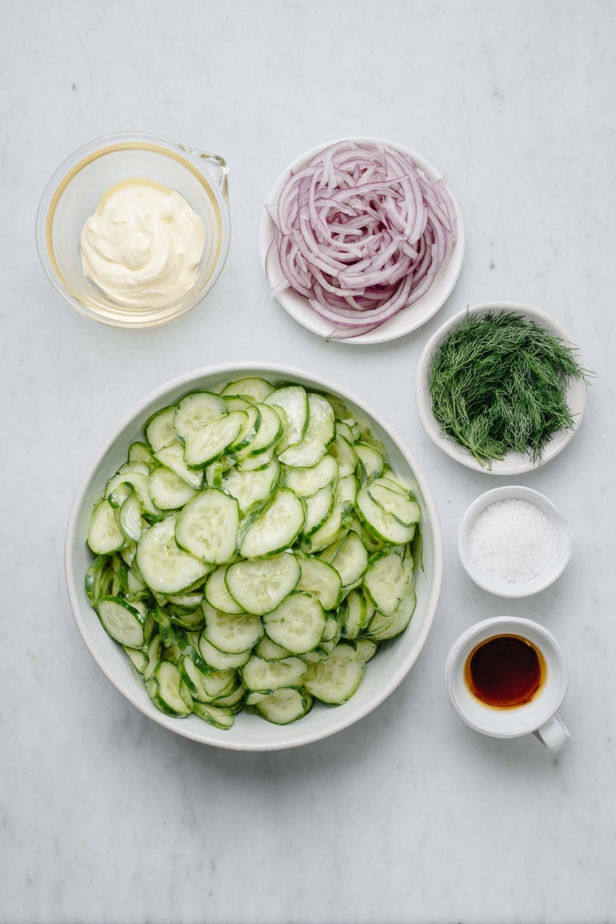 Flat lay of a small pile of thinly sliced pale green cucumbers, a small pile of thinly sliced vibrant red onion rings, a small white ceramic bowl filled with smooth sour cream, a small white ceramic bowl holding clear white vinegar, a few sprigs of bright fresh dill, a small white ceramic bowl of fine granulated white sugar, a small white ceramic bowl with coarse white salt crystals, a small white ceramic bowl containing light beige garlic powder, placed on a clean white marble surface, soft natural light, photo taken with an iPhone, professional food photography style, fresh ingredients, white ceramic bowls, no bottles, no duplicates, no utensils, no packaging --ar 2:3 --v 7 --p m7354615311229779997 - Creamy Cucumber Salad with Dill, easy cucumber salad, fresh dill cucumber side, cool summer salad, healthy cucumber recipes